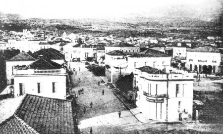 Η Σιδηροδρομικού Σταθμού από το υπερώο της Μεγάλης Βρετάνιας, στο βάθος της φωτογραφίας το κτήριο της Λαϊκής Σχολής